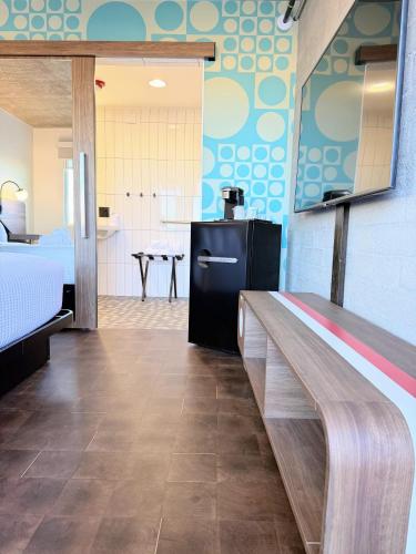 a large room with a bed and a kitchen at The Alice Hotel in Tucson