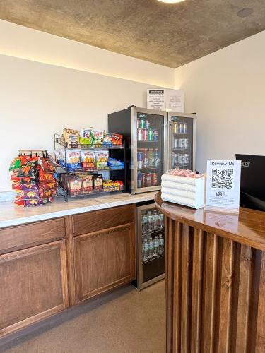 a store with a counter with drinks and a refrigerator at The Alice Hotel in Tucson