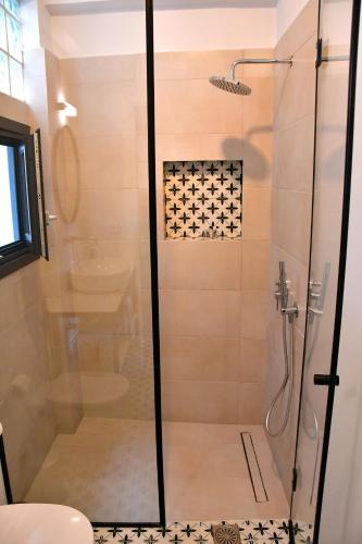 a shower with a glass door in a bathroom at Aegina-town-old-center in Aegina Town