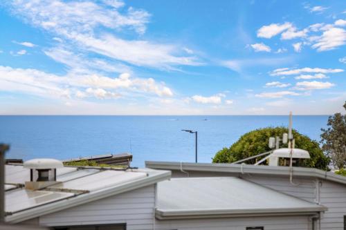 a view of the ocean from the roof of a building at Reflections Seal Rocks - Holiday Park in Smiths Lake