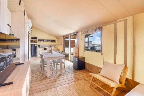 a kitchen and dining room with a table and chairs at Reflections Seal Rocks - Holiday Park in Smiths Lake