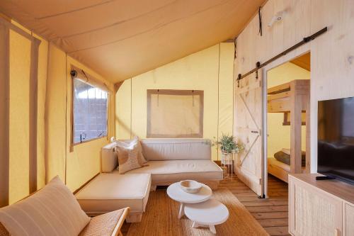 a living room with a couch and a tv at Reflections Seal Rocks - Holiday Park in Smiths Lake