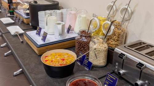 a counter topped with jars of food and other ingredients at Rija Domus Hotel in Rīga