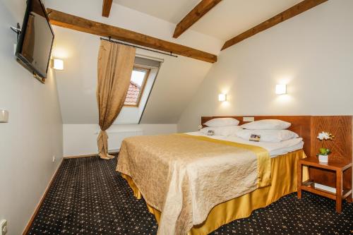 a hotel room with a bed and a television at Vihula Manor Country Club & Spa in Vihula