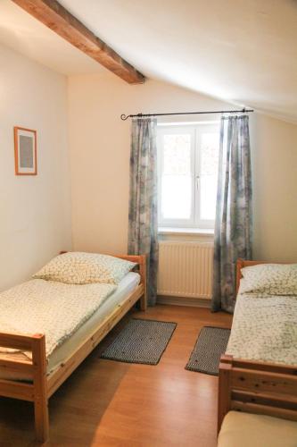 a bedroom with two beds and a window at Villa Silvanus in Ebensee
