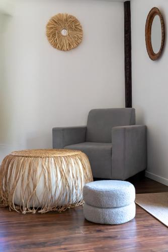 a living room with a couch and a ottoman at U Story Resort in Siquijor