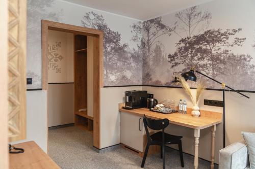 a room with a desk and a table with a chair at Kompleks Antałówka Termy & Med in Zakopane