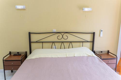 a bedroom with a large bed with two night stands at Remezzo Apartments in Sami