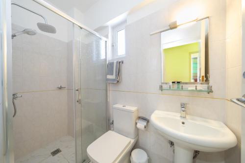 a bathroom with a toilet and a sink and a shower at Remezzo Apartments in Sami