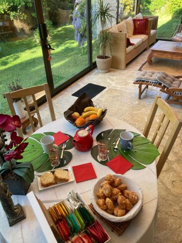a table with food on it in a living room at Tajitu chambre table d hôte naturiste FKK in Chartres