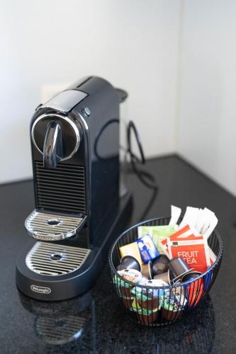 a toaster sitting on a counter with a basket of food at Gartenoase by Greatlifestay in Ennetbürgen
