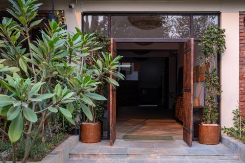 an open entrance to a building with plants at Heirloom Guesthouse in Dimāpur