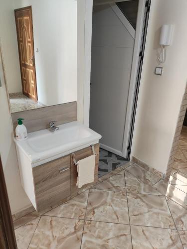 a bathroom with a sink and a mirror at Flat Al farabi in Agadir