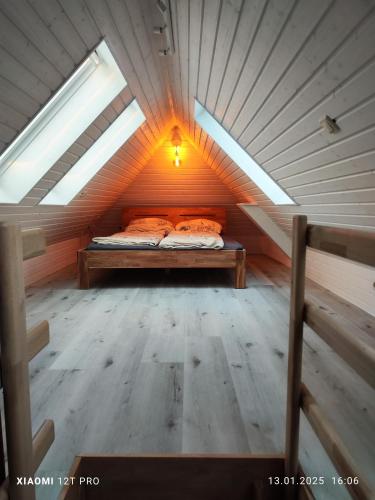 a bed in the middle of a room in a attic at Chalets in nature Nedderhagen in Damshagen