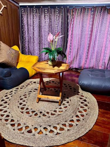 a living room with a table and a couch at Surelee Homestay in Sa Pa