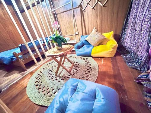 a living room with a blue couch and a table at Surelee Homestay in Sa Pa