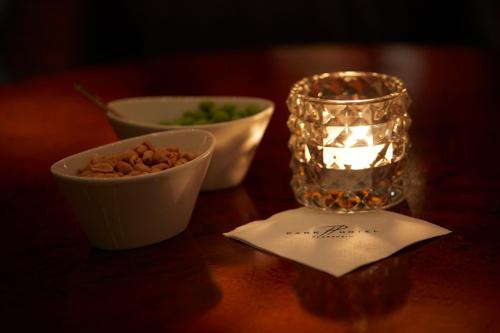 a table with a candle and a bowl of nuts at Parkhotel Pforzheim in Pforzheim