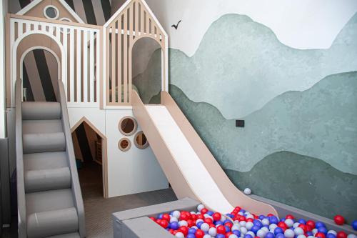 a childs play room with a slide and balls at Novotel World Trade Centre Dubai in Dubai