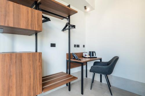 a room with a table and a chair and a desk at Onyx Hotel in St Julian's