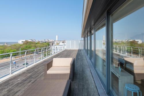 a balcony of a building with a bench on it at Penthouse Ostend with Seaview in Ostend