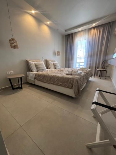 a bedroom with a large bed and a window at Akrogiali in Skala