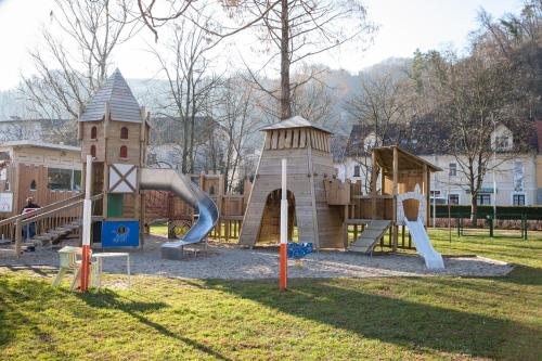 a playground with a slide in a park at Apartments Artorius Laško in Laško