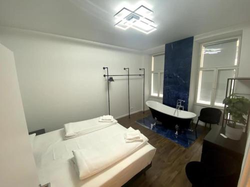 a bathroom with a bed and a bath tub at Notorious Design Apartments - near Kärntner Straße in Vienna