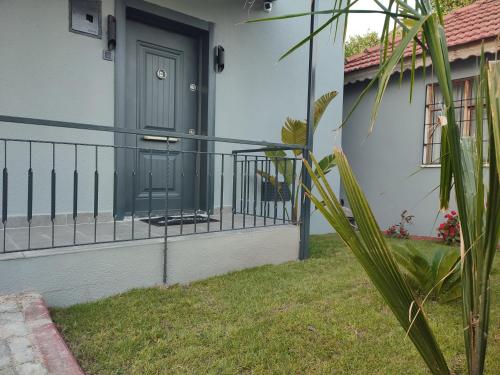 a house with a green door and a fence at Villa PALA in Kemer
