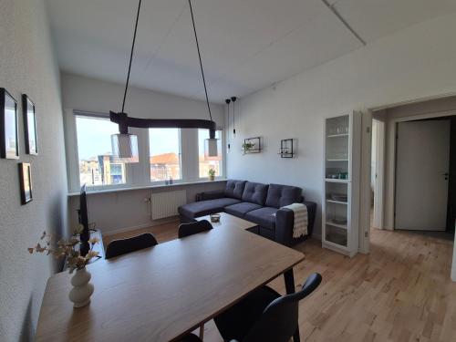 a living room with a table and a couch at Urban Stay Herning in Herning