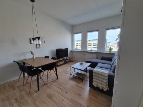 a living room with a couch and a table at Urban Stay Herning in Herning