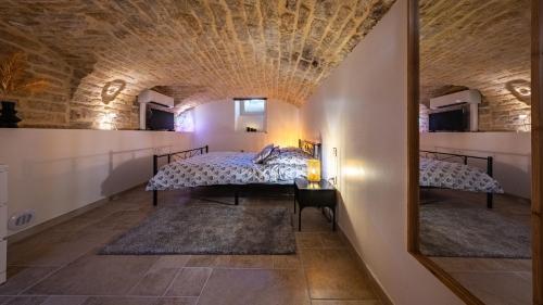 a room with two beds and a stone ceiling at Le loft sur rivière in Dijon