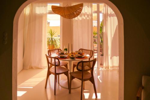a dining room with a table with chairs and an umbrella at Casa Palmita Costa Calma in Costa Calma