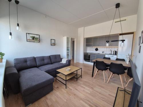 a living room with a couch and a table at Urban Stay Herning in Herning