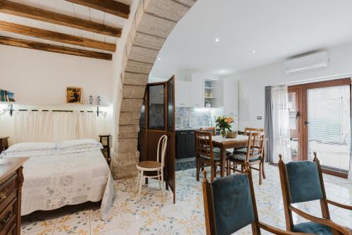 a bedroom with a bed and a table and chairs at Ai Cannola - Calatafimi Segesta in Calatafimi
