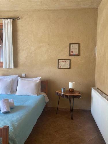 a bedroom with a bed and a small table at Kardama HideAway in Kato Amiandos