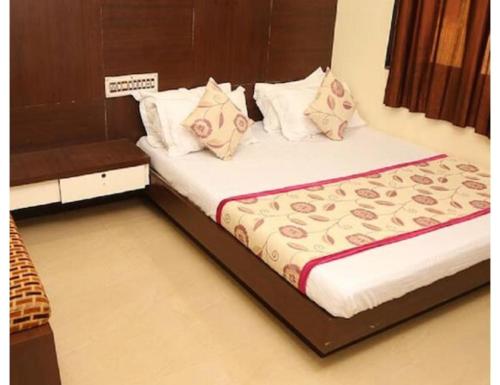 a bed in a room with two pillows at Hotel heena plaza, mount abu in Mount Ābu