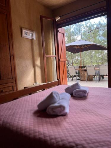 a bedroom with a bed with purple sheets and an umbrella at Kardama HideAway in Kato Amiandos