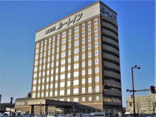 a large building with a sign on top of it at Hotel Route-Inn Kitami Odorinishi in Kitami