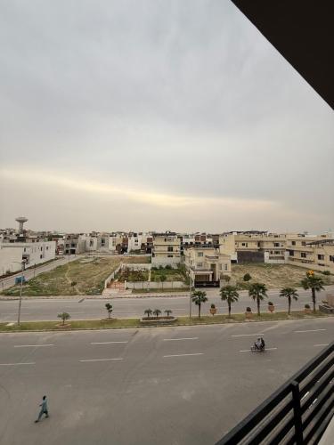 an empty parking lot with buildings in the background at Modern Flat with Balcony in Wāh