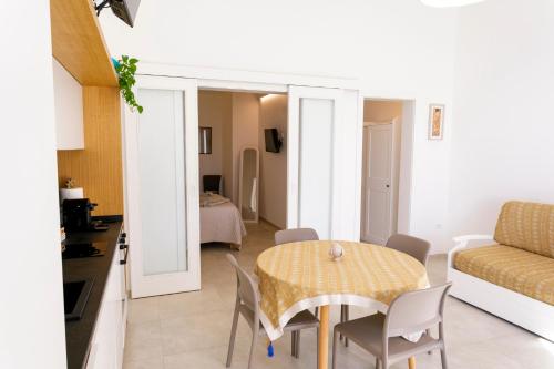 a living room with a table and a couch at Lo Scirocco in Nardò