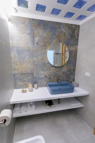 a bathroom with a sink and a mirror at Lo Scirocco in Nardò