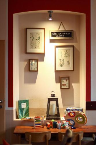 a room with a table and chairs and a wall with pictures at Landhaus Hammoor Stieper Gastronomie GmbH in Hammoor