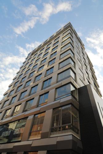 a tall building with a blue sky in the background at Akasaka Granbell Hotel in Tokyo