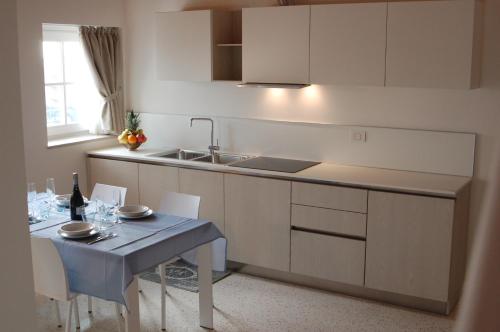 a kitchen with a table and a sink and a counter at Quirinus Venetia Properties in Mestre