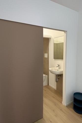 a bathroom with a sink and a mirror at Blusanvito in San Vito lo Capo