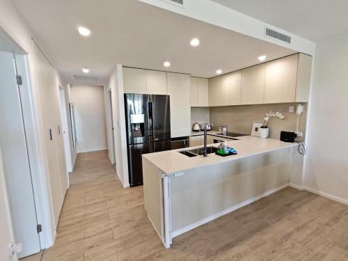a kitchen with a sink and a counter top at Luxury 3BR, 2BA Unit with Pool & BBQ in Gold Coast in Gold Coast
