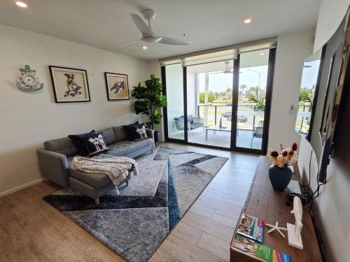 a living room with a couch and a table at Luxury 3BR, 2BA Unit with Pool & BBQ in Gold Coast in Gold Coast