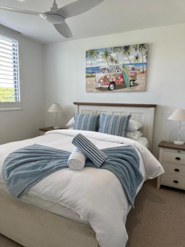 a bedroom with a bed with towels on it at Luxury 3BR, 2BA Unit with Pool & BBQ in Gold Coast in Gold Coast