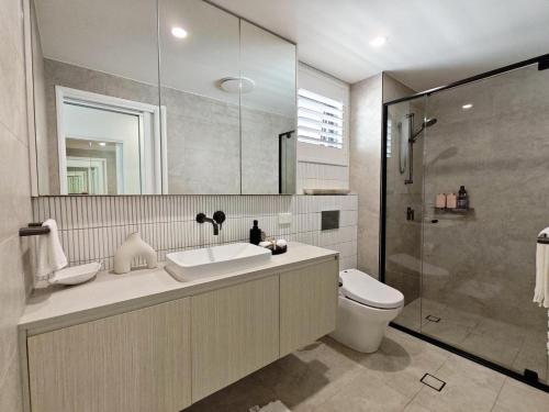 a bathroom with a sink and a toilet and a shower at Luxury 3BR, 2BA Unit with Pool & BBQ in Gold Coast in Gold Coast