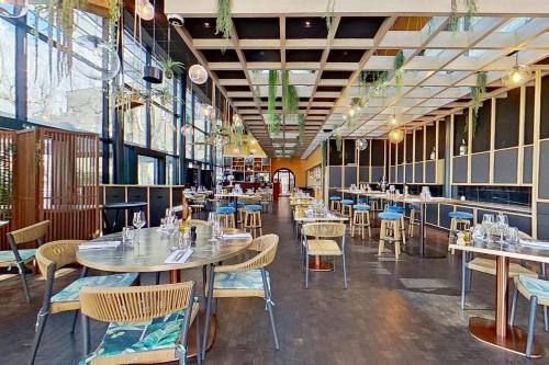 a restaurant with tables and chairs in a room at Aquabella Hôtel & Spa in Aix-en-Provence